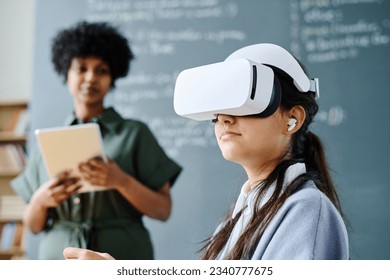 Student in VR glasses sitting at lesson - Powered by Shutterstock