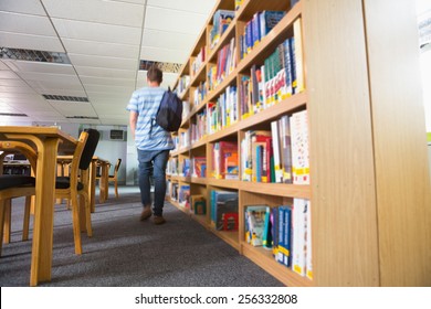 Student Walking Away In The Library At The University