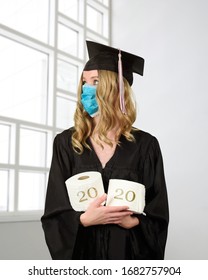 A Student Is Wearing A Graduation Cape And Robe Holding Toilet Paper For A Humorous Concept Of The Class Of 2020 Coronavirus Pandemic Of The Covid-10 Shutdown.