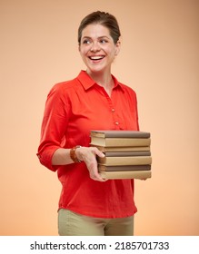 Student Woman In Red Shirt Holding Book Stack Looking Back Over Shoulder, Isolated Studio Portrait On Beige, Brown Background.