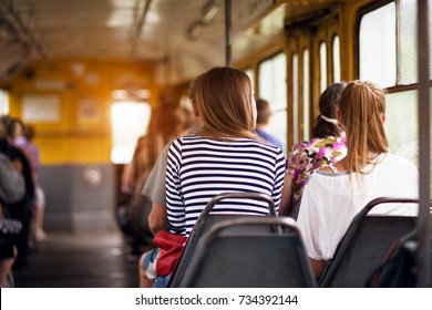 Student Women Taking A Ride In Public Transport From The Work At Sunset Time