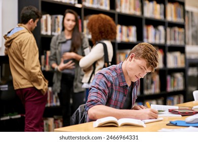 Student, writing and notebook in library for study, education and university quiz with pen on table. Man, books and knowledge on school campus for college, research and learning with scholarship - Powered by Shutterstock