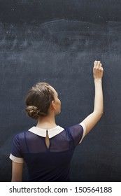 Student Writing On The Chalkboard