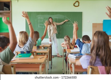 Students answering the teacher's question in a maths lesson. - Shutterstock ID 172266500