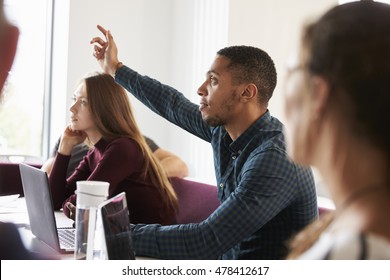 Students Asking Question Whilst Attending Lecture On Campus