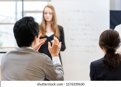 Students Asking Teachers Questions In An English Conversation Class