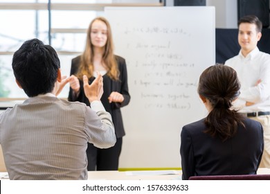 Students Asking Teachers Questions In An English Conversation Class