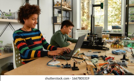 Students Building And Learning To Program Robot Vehicle At A Stem Robotics Class. Science And Education. Inventions And Creativity For Kids.