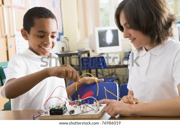 Students in class with\
electronic project