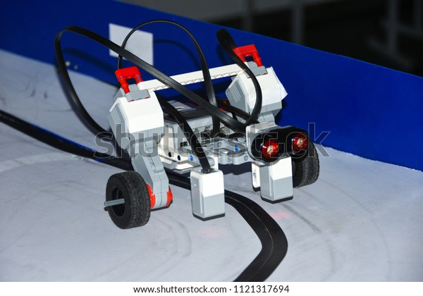 Students code car robot and an\
electronic board. Robotics and electronics. Laboratory.\
Mathematics, engineering, science, technology, computer code. STEM\
education.