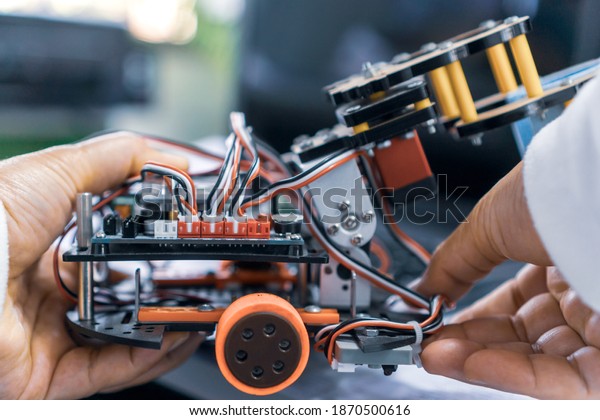 Students code learning in car robotics on\
electronic board with construction equipment in laboratory of\
school. Concept of STEM education related of mathematics,\
engineering, science, technology\
study