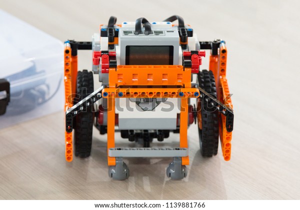Students code\
a plastic car robot and an electronic board. Robotics and\
electronics. Laboratory. Mathematics, engineering, science,\
technology, computer code. STEM education.\

