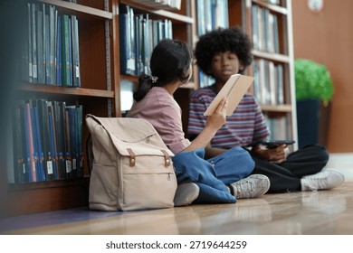 Students collaborating on study tasks inside library reflecting knowledge exchange academic growth education routine.