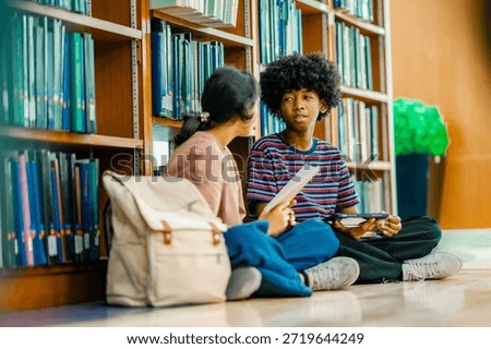 Students collaborating on study tasks inside library reflecting knowledge exchange academic growth education routine.