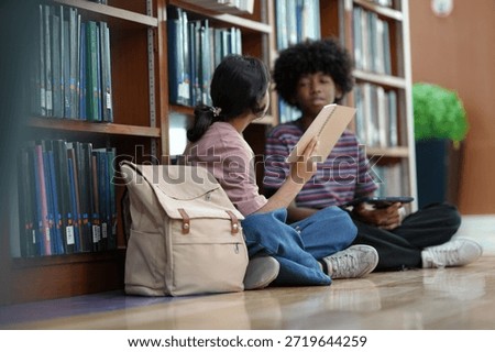 Students collaborating on study tasks inside library reflecting knowledge exchange academic growth education routine.