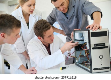 Students In Computing Class With Teacher Fixing Hardware