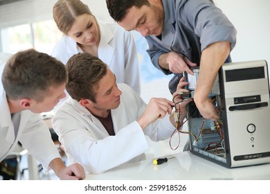 Students In Computing Class With Teacher Fixing Hardware