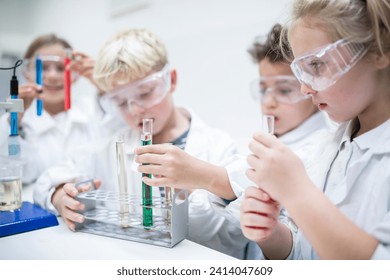 Students conducting liquid experiments in a science classroom using test tubes - Powered by Shutterstock