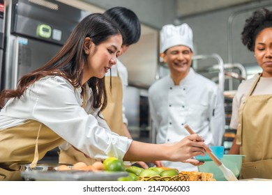 Students In Cookery Class Mixing Ingredients For Recipe In Kitchen.Male And Female young  Students With chef Teacher Preparing Ingredients For Dish In Kitchen Cookery Class. - Shutterstock ID 2147066003