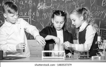 students doing biology experiments with microscope in lab. Little kids learning chemistry. Looking at the future of science. Chemistry education. Happy children. Chemistry lesson. Chemistry equipment.