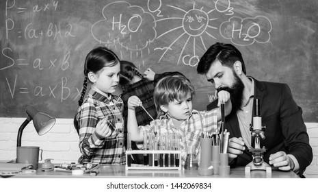 students doing science experiments with microscope in lab. school kids scientist studying science. happy children teacher. back to school. Little kids learning chemistry in school laboratory.