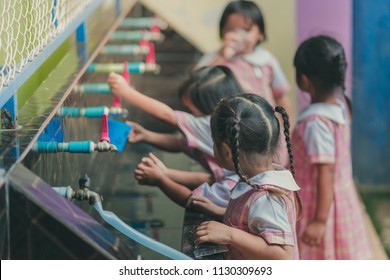 Students Drinking Water From The Faucet After Lunch.