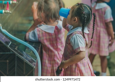 Students Drinking Water From The Faucet After Lunch.