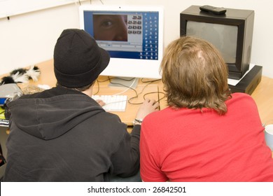 Students Editing Video On Computer In Classroom