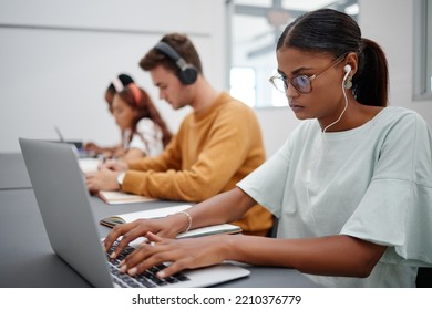 Students, Elearning And Laptop In Classroom Education, Learning And Studying With Technology Indoors. Focused Woman Typing Research Essay Or Project On Computer At University, College Or School