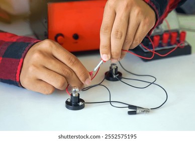 Students experiment with simple electronic circuits. Principles of traffic light circuits. Soft and selective focus.                               