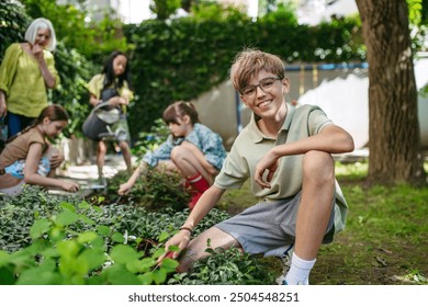 Students and female teacher at outdoor sustainable education class. Kids taking care of plants in school garden. Concept of experiential learning and ecoliteracy. - Powered by Shutterstock