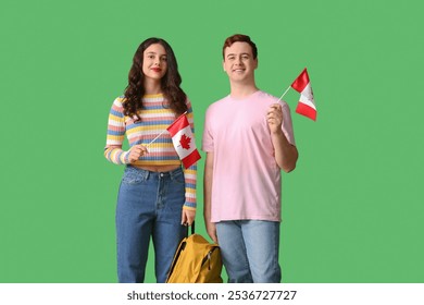 Students with flags of Canada and backpack on green background