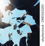 Students, happy and graduation cap in sky on campus with celebration and success. People, college and university classmate or friends with pride or excited for qualification competition in low angle