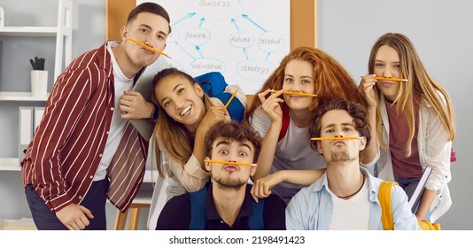 Students Having Fun Together. Group Portrait Of Funny School, College Or University Friends. Bunch Of Happy Young Diverse People With Pencil Mustaches Making Funny Faces And Looking At Camera