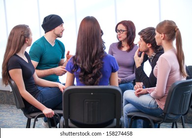 Students Having Workshop. Young Man Talking While All Listening 