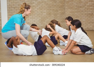 Students helping other students exercise at the elementary school - Powered by Shutterstock