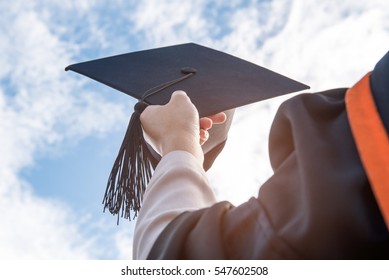 The students holding a shot of graduation cap by their hand in a bright sky during ceremony success graduates at the University, Concept of Successful Education in Hight School,Congratulated Degree  - Shutterstock ID 547602508