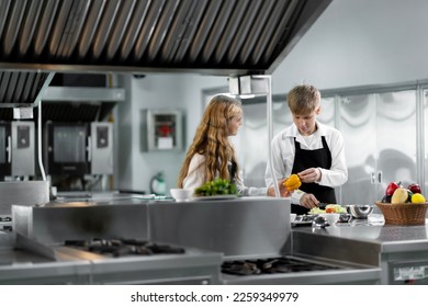 Students are learning to cook in a culinary institute with a standard kitchen and complete equipment. And have a professional chef as a trainer. - Shutterstock ID 2259349979