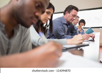 Students in a lecture with one woman looking up in college