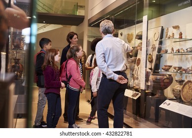 Students Looking At Artifacts In Case On Trip To Museum - Powered by Shutterstock