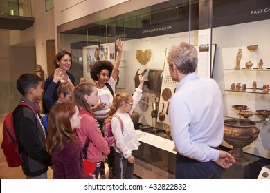 Students Looking At Artifacts In Case On Trip To Museum - Powered by Shutterstock