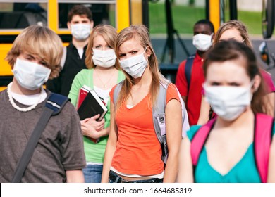 Students Near A School Bus Wearing Medical Masks.