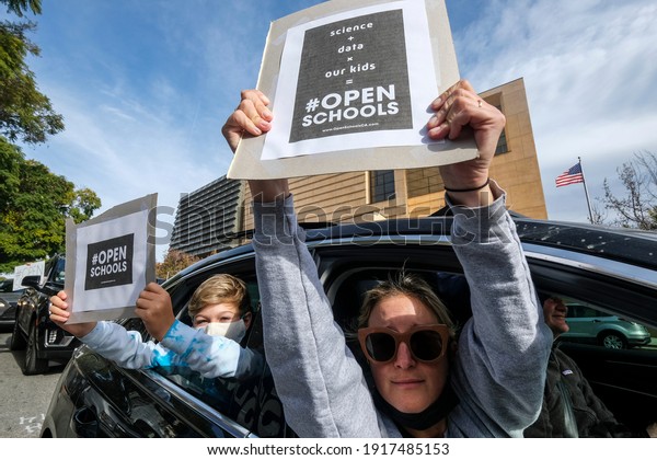 Students and parents holding placards in their
car protest during a car rally to encourage Los Angeles County to
reopen schools during the Coronavirus pandemic Monday Feb. 15, 2021
in Los Angeles.