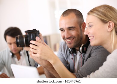 Students in photography working together on project - Powered by Shutterstock