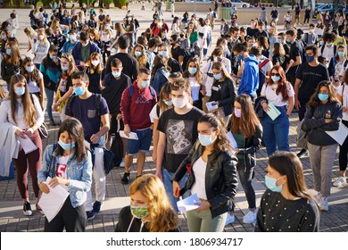 Students queuing at the school entrance wearing mask face to prevent infection or respiratory illness. Turin, Italy - September 2020