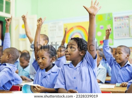 Students raising hands in class