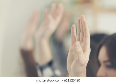 Students Raising Hands In Classroom.