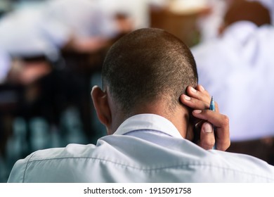 Students Reading Exam Answer Sheets Exercises In Classroom Of School With Stress