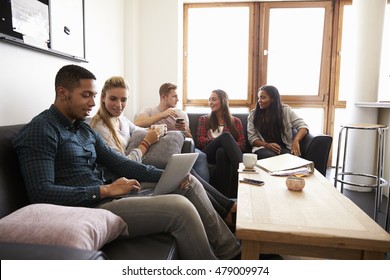 Students Relaxing In Lounge Of Shared Accommodation