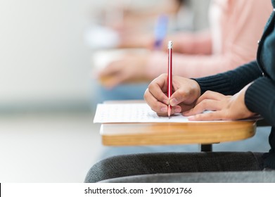 Students sit for exams at the desks in the classroom at the university.